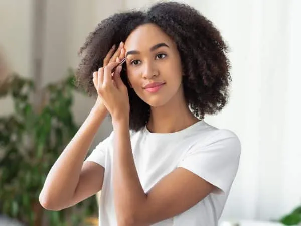 ragazza che fa epilazione sul viso con pinzette